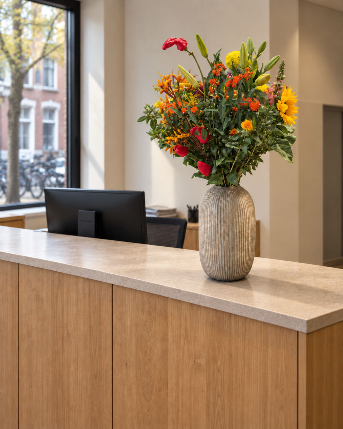 Hosman bloemenabonnement op een receptiebalie van een kantoor in Utrecht